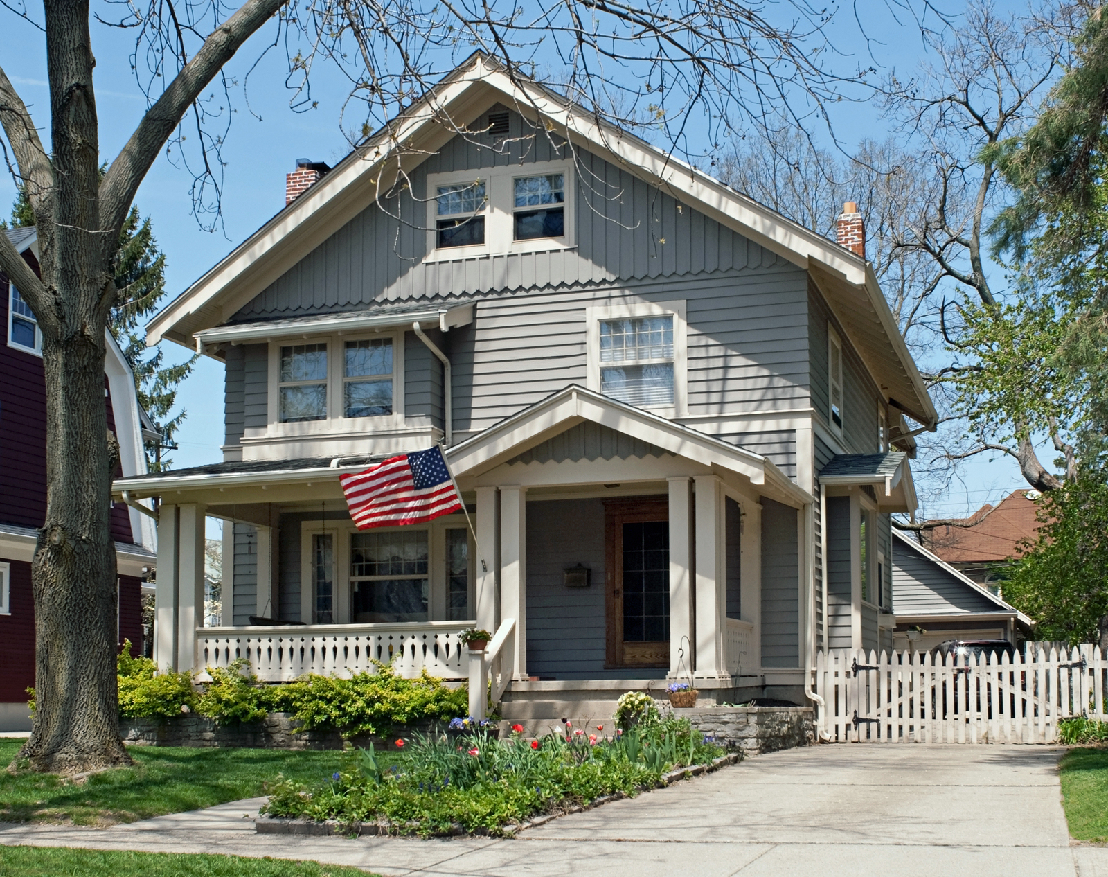 Classic American home with porch and flag in Lake Zurich, Illinois